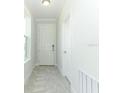Welcoming hallway with tile floors and white trim around the door and window frames at 1328 Lombardi Ct, Poinciana, FL 34759