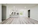 Bright, open-concept layout showcasing the living room and kitchen with stainless steel appliances at 15621 Sw 37Th Cir, Ocala, FL 34473