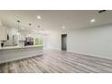 Modern open-concept living space with stainless steel appliances and hardwood floors at 15621 Sw 37Th Cir, Ocala, FL 34473