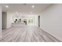 Spacious living area featuring hard wood flooring and an open-concept design connecting to the kitchen at 15621 Sw 37Th Cir, Ocala, FL 34473