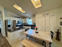 Eat-in kitchen featuring stainless steel appliances, granite countertops, a pantry, and tile flooring at 1659 Canton Ln, Oviedo, FL 32765