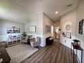 Inviting living area with wood floors, wainscoting, vaulted ceilings, and comfortable seating at 1659 Canton Ln, Oviedo, FL 32765