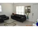 Inviting living room with tile flooring, modern furniture, a large mirror and bright, natural light at 233 N Hudson St, Orlando, FL 32835