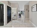 Hallway featuring marble-look tile floors and views into other rooms at 311 Eaglecrest Dr, Haines City, FL 33844
