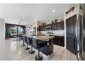 Bright kitchen with a large island, bar stool seating, stylish lighting, and modern appliances at 311 Eaglecrest Dr, Haines City, FL 33844