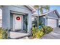 Welcoming front entrance featuring a decorative wreath and lush landscaping at 316 Bennett St, Auburndale, FL 33823