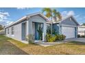 Beautiful single-story home featuring a well-kept lawn, attractive landscaping, and a 2-car garage at 316 Bennett St, Auburndale, FL 33823