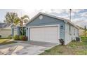 A two-car garage with a freshly painted white door that matches the house's trim at 316 Bennett St, Auburndale, FL 33823