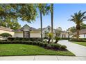 Charming home with lush landscaping, mature trees, and a well-maintained lawn creating inviting curb appeal at 3267 Regal Crest Dr, Longwood, FL 32779