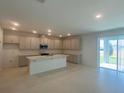 Open-concept kitchen and dining area with sliding glass doors to the patio at 335 Ridgemark Ave, Groveland, FL 34736