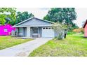 Charming single-story home with a well-maintained lawn and driveway, attached one car garage at 3362 Janet St, Apopka, FL 32712