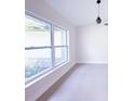 A bright living room with large windows and recessed lighting offers a seamless blend of elegance and comfort at 3417 Bay Meadow Ct, Windermere, FL 34786