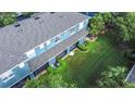 Aerial view of a backyard with a screened lanai, lush grass, and manicured landscaping at 3559 Victoria Pines Dr # 280, Orlando, FL 32829