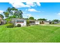 Beautiful home with a sprawling green lawn, manicured bushes, and a quaint, quiet street at 3716 Neptune Dr, Orlando, FL 32804