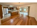 Bright eat-in kitchen featuring hardwood floors, wood cabinets, and stainless steel appliances at 3716 Neptune Dr, Orlando, FL 32804