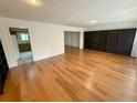 Spacious living room featuring hardwood floors, and a built-in wall bookshelf at 3716 Neptune Dr, Orlando, FL 32804