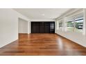 Spacious living room with hardwood floors, a large built-in bookshelf and bright natural light at 3716 Neptune Dr, Orlando, FL 32804