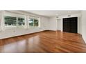 Bright living room featuring beautiful hardwood floors and large windows with lots of natural light at 3716 Neptune Dr, Orlando, FL 32804