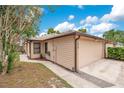 Beige one-story home featuring an attached two-car garage with walkway at 378 Cedarbrook Ln, Altamonte Springs, FL 32714