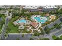 Aerial view of resort pools and recreational area with lush landscaping, cabanas, and lounge chairs at 4114 Breakview Dr # 110, Orlando, FL 32819