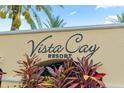 Close up view of Vista Cay Resort sign with vibrant foliage in the foreground at 4114 Breakview Dr # 110, Orlando, FL 32819