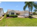 Inviting home featuring a landscaped front yard and a cozy patio, perfect for relaxing outdoors at 449 Timmonsville Way, The Villages, FL 32162