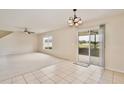 Open dining area featuring tile flooring, chandelier, and sliding glass door access to the outside patio at 4901 Stone Acres Cir, St Cloud, FL 34771
