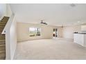 Spacious living area featuring carpet, large window, and sliding door to the outside area at 4901 Stone Acres Cir, St Cloud, FL 34771
