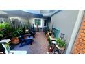 Outdoor patio featuring brick flooring, a privacy fence, chairs, and various potted plants at 525 Oak Ter # 117, Altamonte Springs, FL 32701