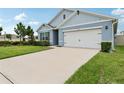 Inviting home showcasing manicured landscaping and a pristine driveway at 585 Talisi Loop, St Cloud, FL 34771