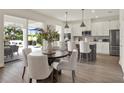 Bright kitchen and dining area with modern appliances, a large island, and sliding glass doors at 6905 Cucamelon Ct, Windermere, FL 34786
