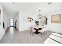 Bright dining room features modern chandelier, decor art and a clear view into the foyer at 9175 Sommerset Hills Dr, Davenport, FL 33896