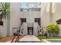 Complex exterior showcasing unit entrances and stairs, set among lush trees at 108 Crown Oaks Way, Longwood, FL 32779