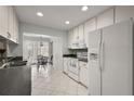 White kitchen featuring stainless steel appliances and eat-in space with natural light at 1105 Apple Ter, Leesburg, FL 34748