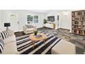 Cozy living room featuring modern furnishings, stylish decor, and beautiful flooring at 1122 Romar Ln, Apopka, FL 32712