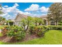 Beautiful single-story home with lush landscaping, flowering bushes, and a three car garage at 11834 Gennaro Ln, Orlando, FL 32827
