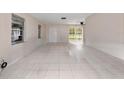 Bright living room featuring tile flooring, large windows, and access to an outdoor patio at 1432 Findlay St, Deltona, FL 32725
