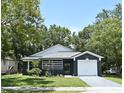 Charming single-story home with a well-manicured lawn and a one-car garage, set amidst lush green trees at 1502 W 16 Th Street, Sanford, FL 32771