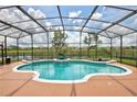 Beautiful kidney-shaped pool with screened enclosure and views of the community lake at 1528 Langham Ter, Lake Mary, FL 32746