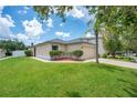Charming home with a two-car garage, landscaped front yard, and a beautiful palm tree at 1531 Tiverton Blvd, Winter Garden, FL 34787