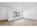 Bright living room features fresh paint and ample sunlight from large windows, perfect for relaxation at 1533 Ravana Dr, Orlando, FL 32822