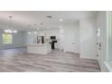 Open-concept living area featuring wood-look floors, stainless steel appliances, and a quartz kitchen island at 15625 Sw 37Th Cir, Ocala, FL 34473