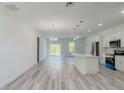 Bright and spacious living room boasts an open floor plan and modern gray wood-look floors at 15625 Sw 37Th Cir, Ocala, FL 34473