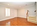 Bright living room featuring hardwood floors, a staircase, and plantation shutters at 1649 Lake Baldwin Ln, Orlando, FL 32814