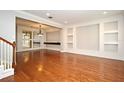 Open living room area with hardwood floors, modern lighting, and custom wall details at 1649 Lake Baldwin Ln, Orlando, FL 32814