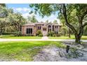 Beautiful brick home featuring a meticulously maintained lawn and mature landscaping at 1717 Fountainhead Dr, Lake Mary, FL 32746