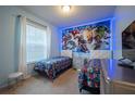 Charming themed bedroom with two twin beds, large window, and a bright accent wall at 1935 Majorca Dr, Kissimmee, FL 34747