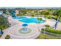 Community pool with a fountain feature, water slides, and many lounge chairs at 2031 Gloria Oak Ct, Orlando, FL 32820