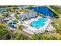 Aerial view of a community pool with a fountain, waterslides, and lounge chairs at 2031 Gloria Oak Ct, Orlando, FL 32820