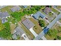 Aerial view of home showing roof, driveway and proximity to nearby neighbors at 2033 E Gloria Dr, Deltona, FL 32725